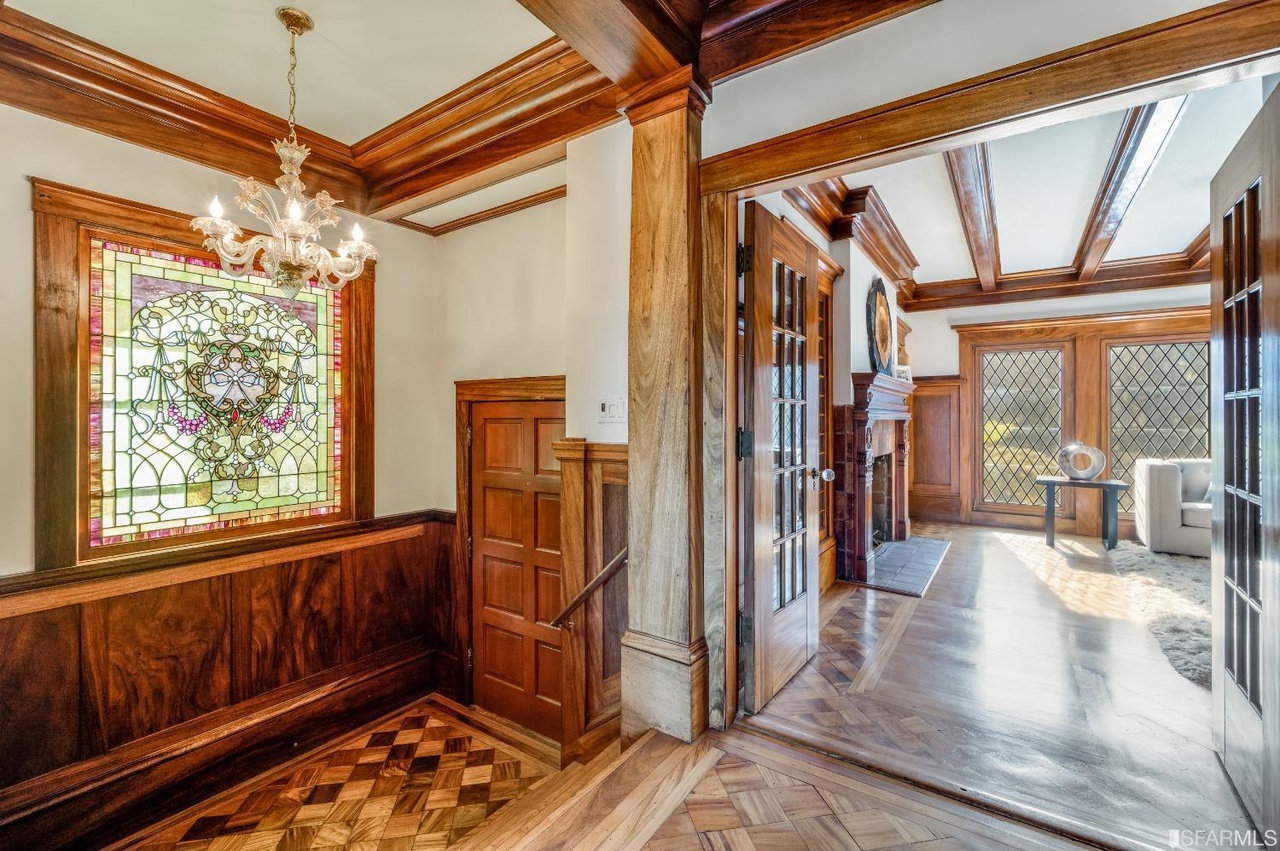 Property Photo: Hallway with wood floors, wood beamed ceilings and stained glass windows