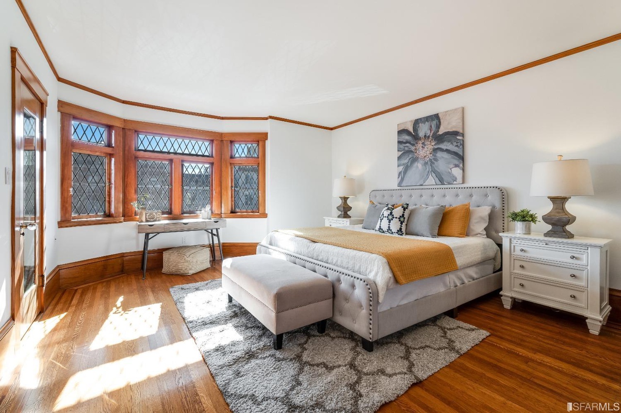 Property Photo: Bedroom two, showing wood floors and large bay windows
