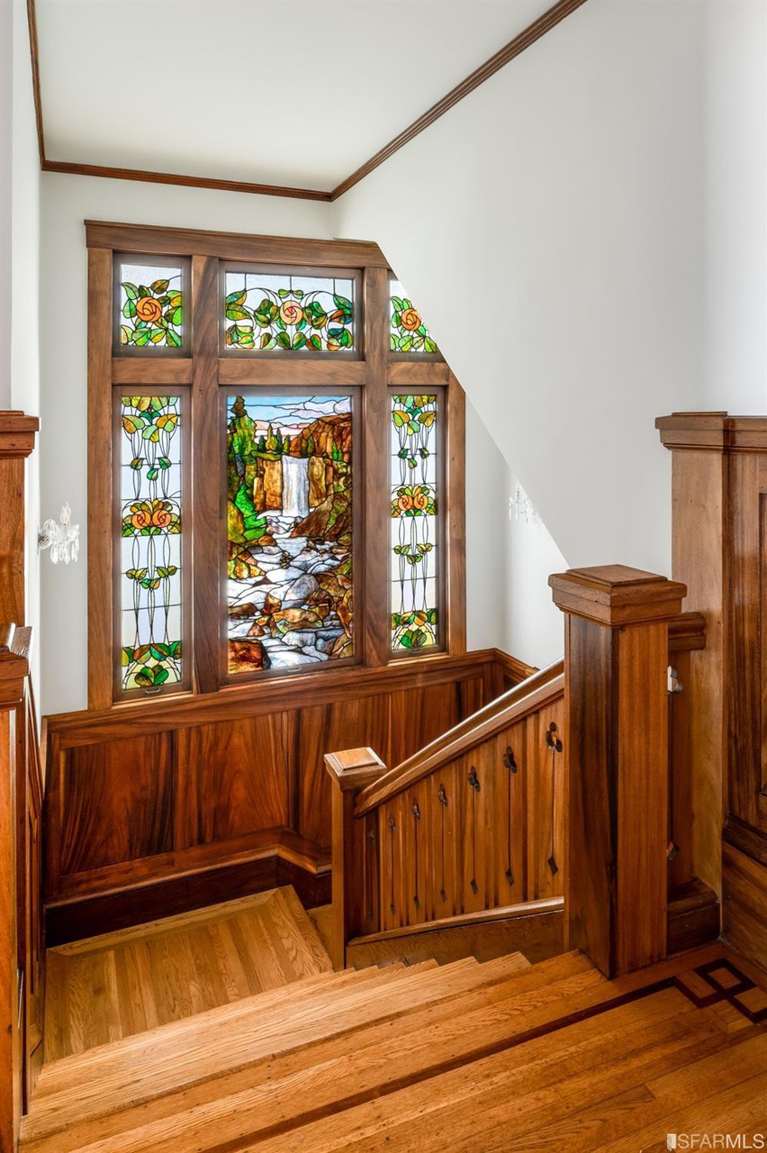 Property Photo: Ornate stained glass windows in the stairway