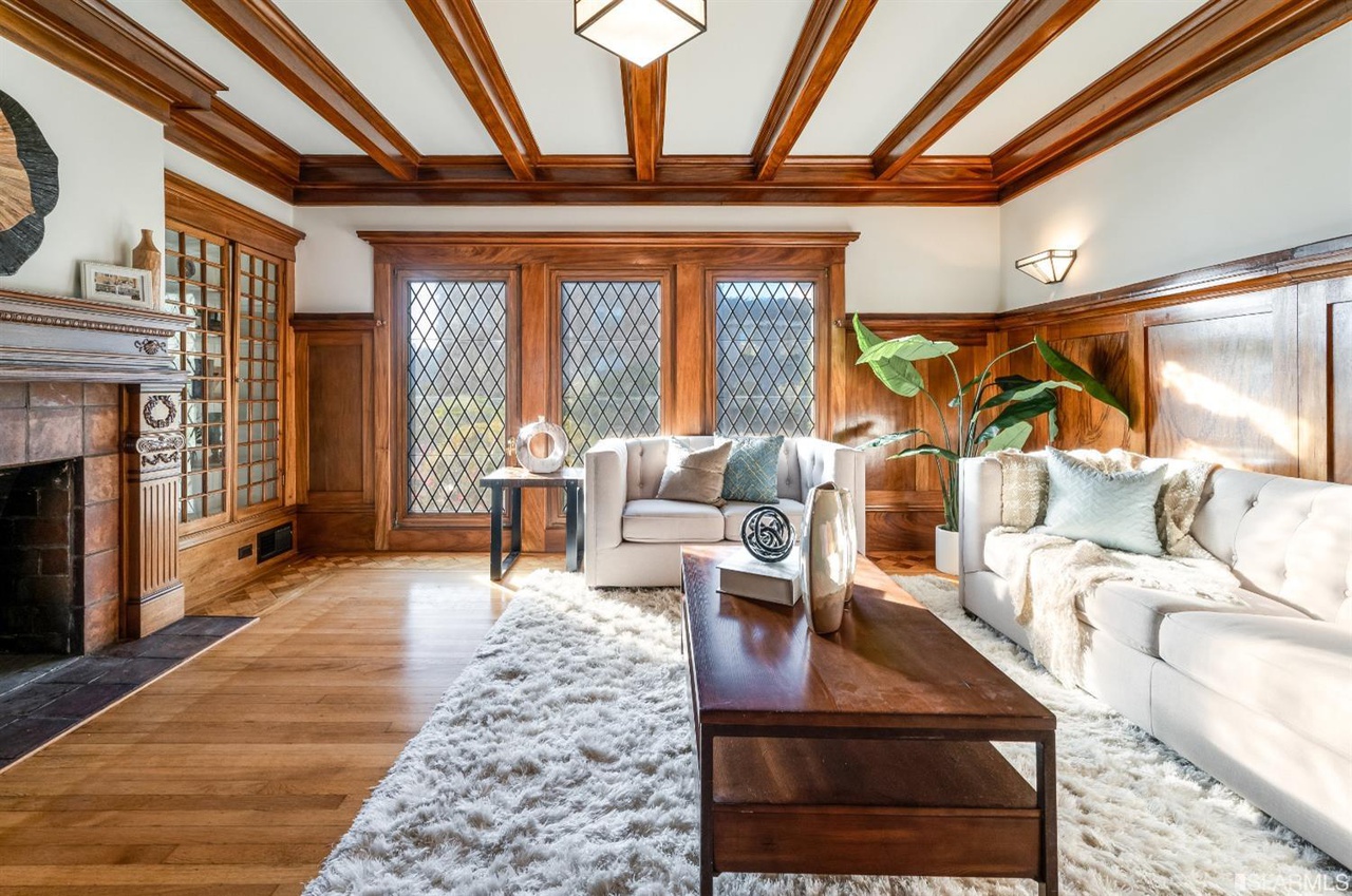 Property Photo: View of the living room, showing wood beamed ceilings and wood floors