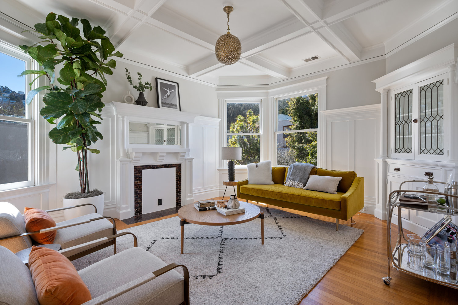 Property Photo: View of the living room with boxed beamed ceilings