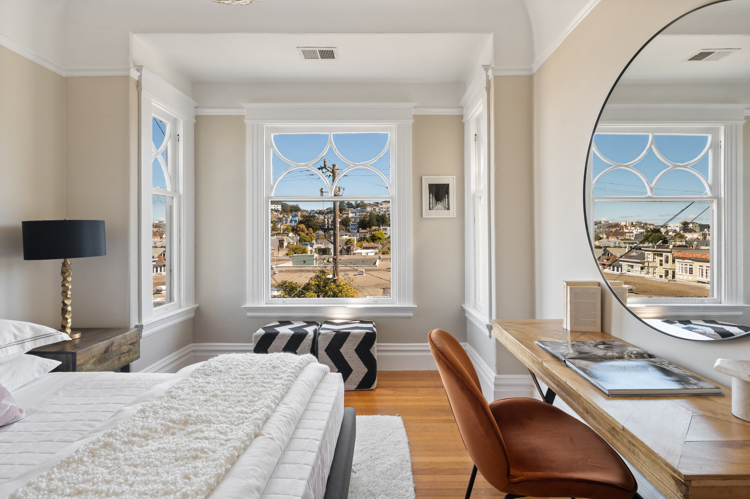 Property Photo: View of bedroom one, featuring wood floors and view of Cole Valley