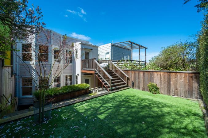 Property Thumbnail: Looking back to stairway from backside of yard. Lots of green area. 