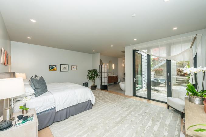Property Thumbnail: Primary suite. There is large floor to ceiling doors that open up to lower patio.