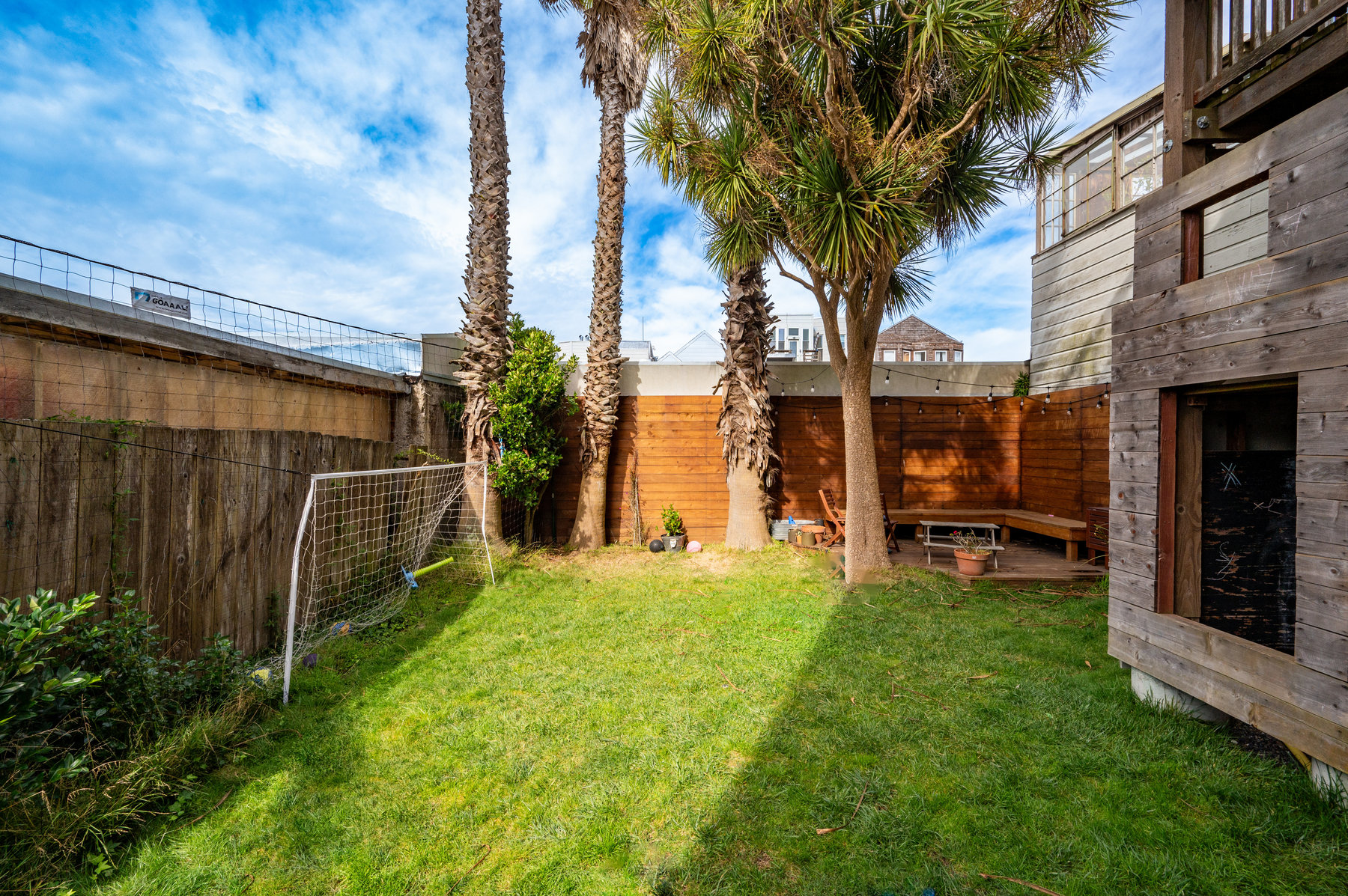 Property Photo: Photo of shared backyard highlighting the green grass yard. 