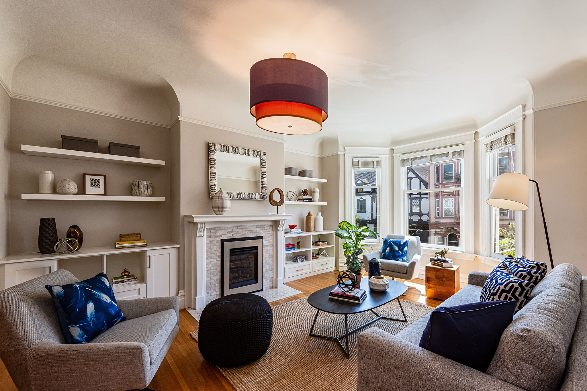 Property Photo: View of the living room, showing a fireplace with white shelving on either side