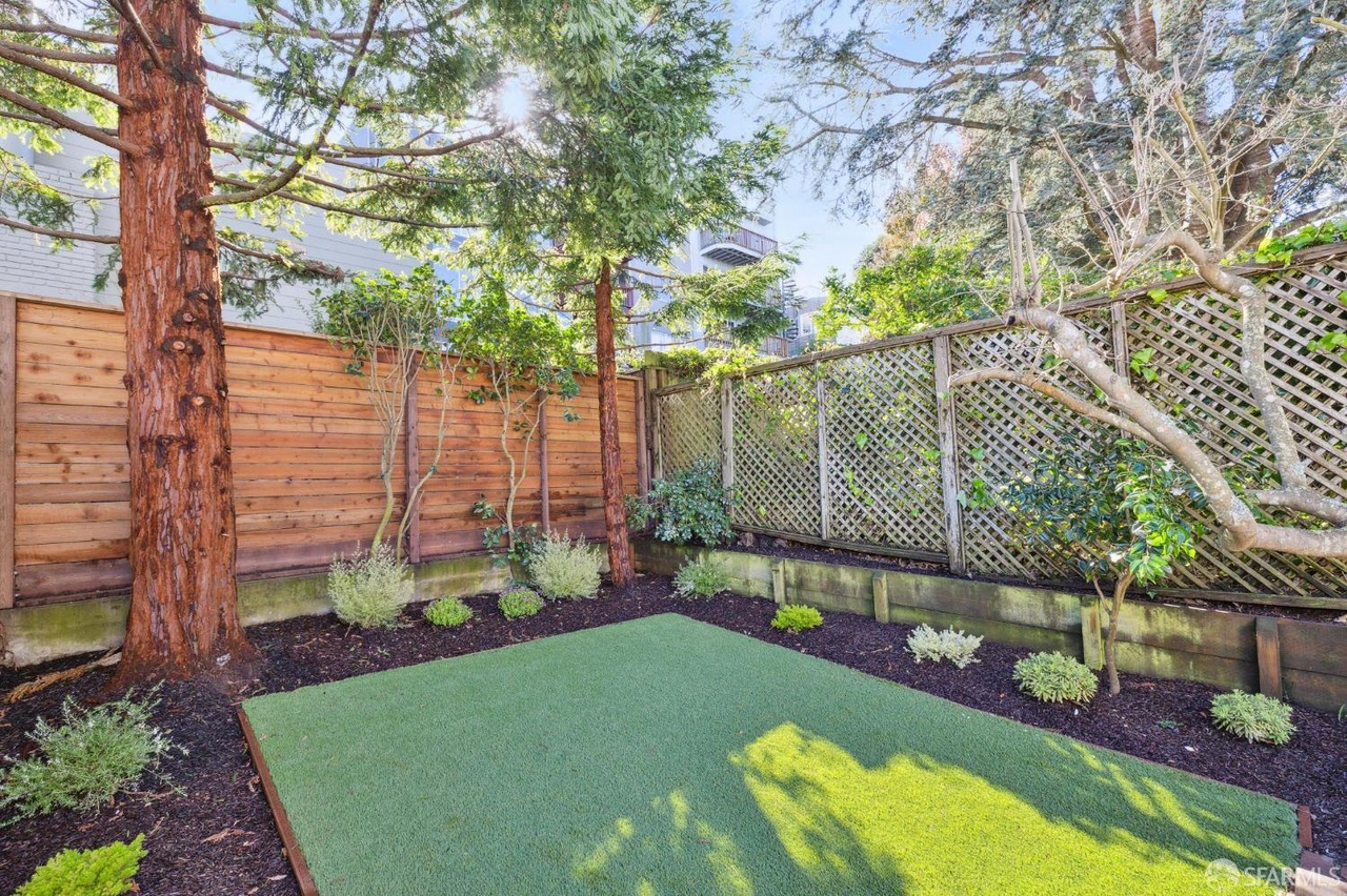 Property Photo: There is a turf grass area in back yard. 