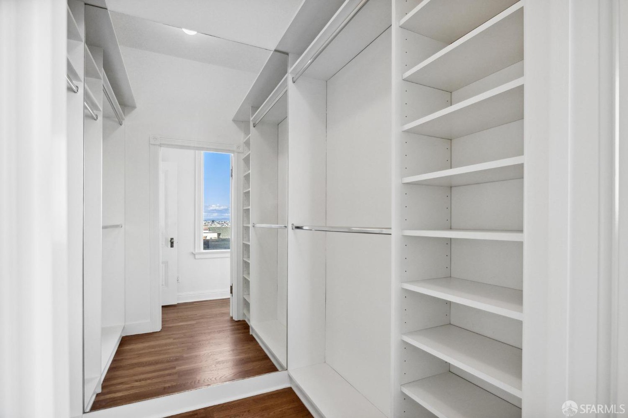 Property Photo: Large walk in closet. There is mirror on back wall that makes closet look large.