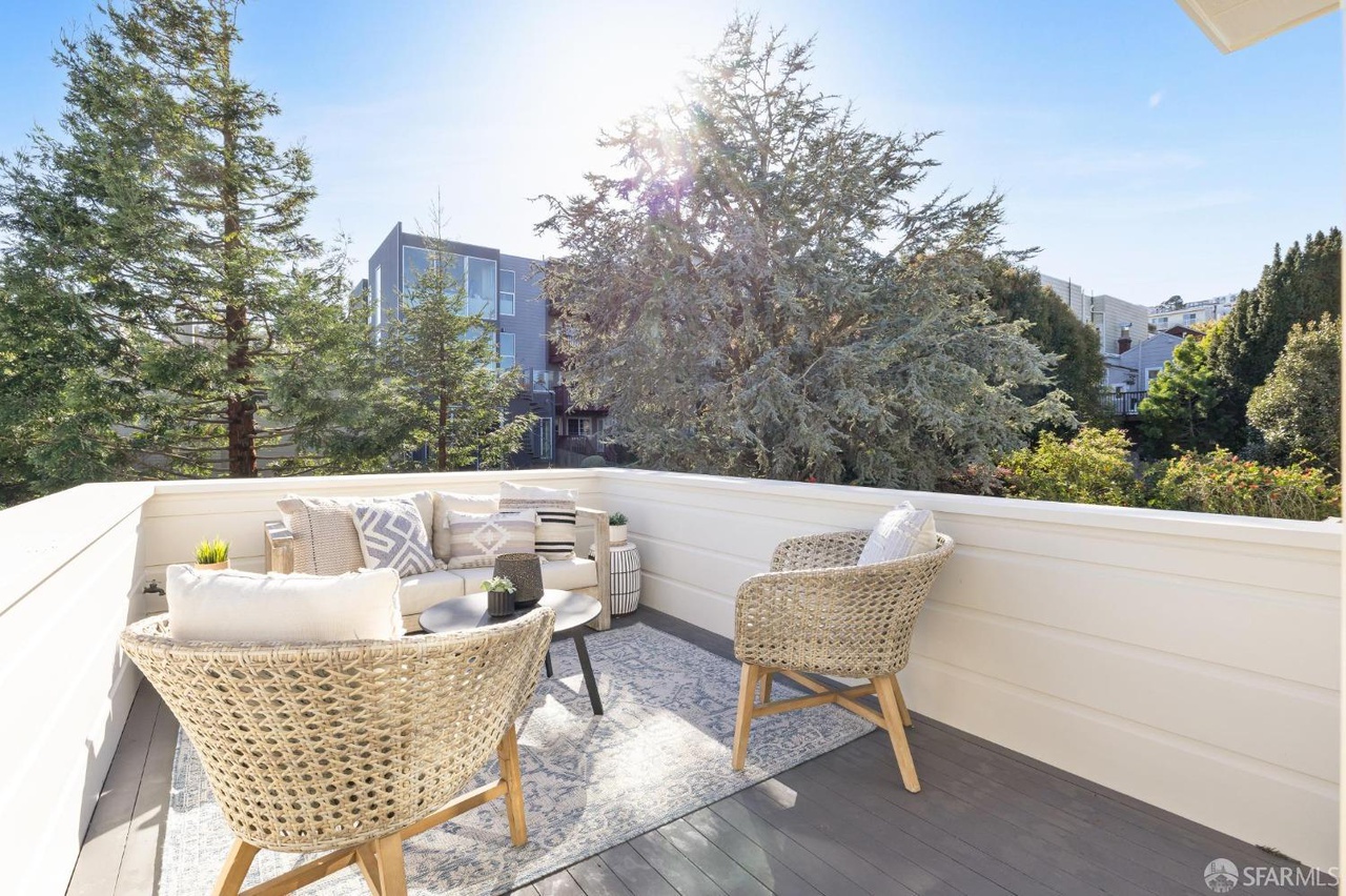 Property Photo: Patio off the guest room has sitting area. There are some nice tall trees for privacy. 