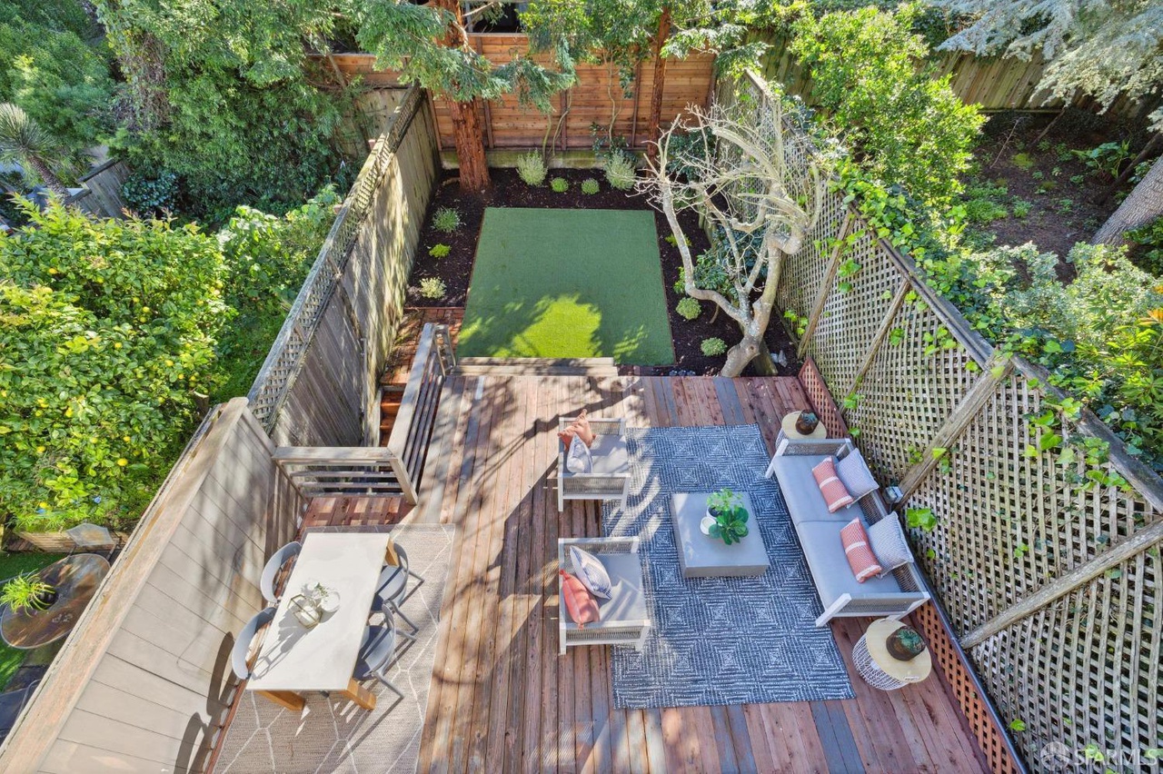 Property Photo: Looking down onto lower deck/yard area from upper patio. 