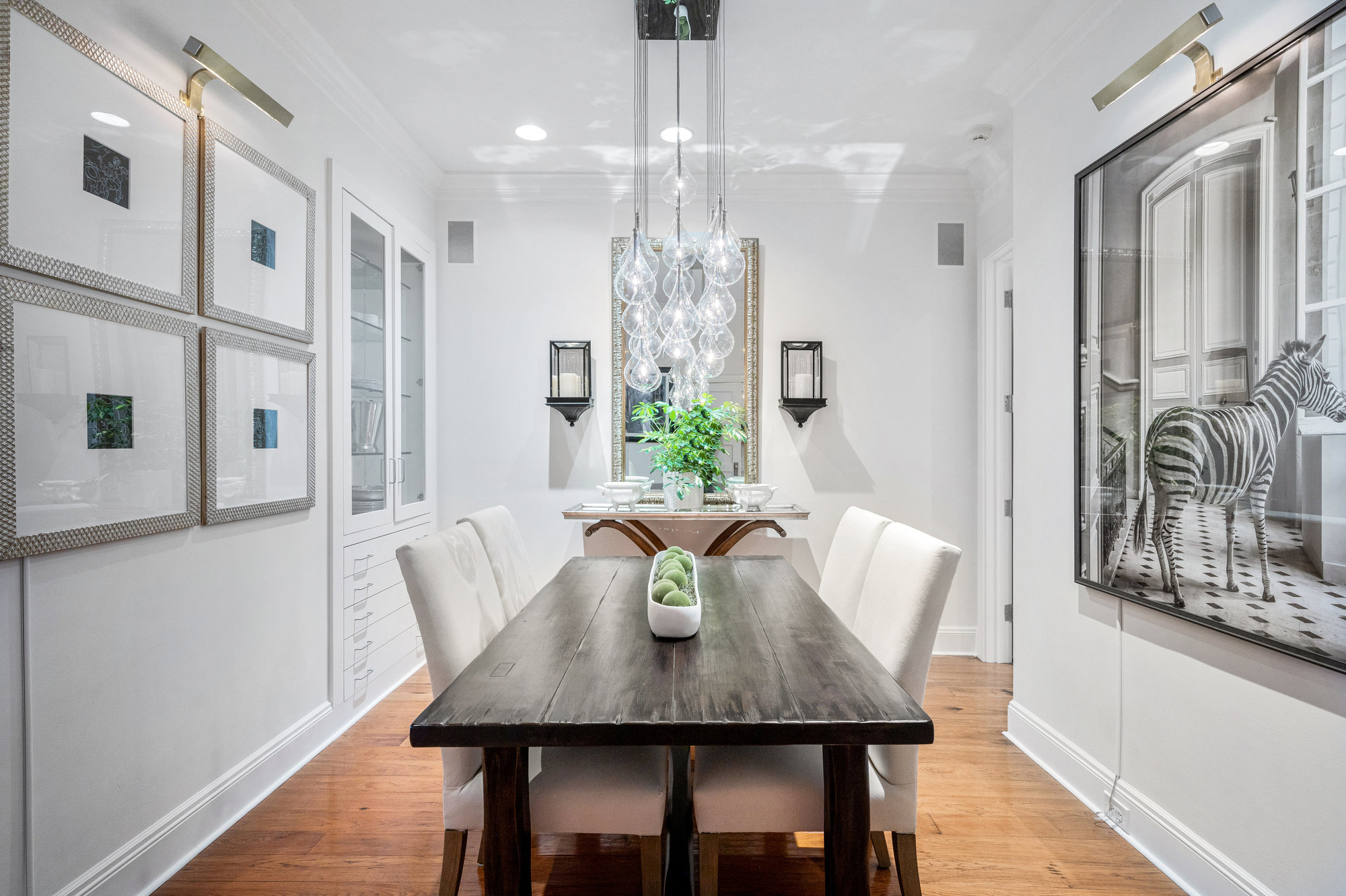 Property Photo: This is a centered photo showing the dining table. It is rectangular and fits 4. There is amazing light fixture over table. 