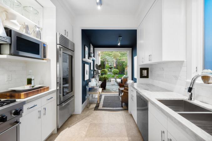 Property Thumbnail: Looking though kitchen to back door that looks out to backyard.