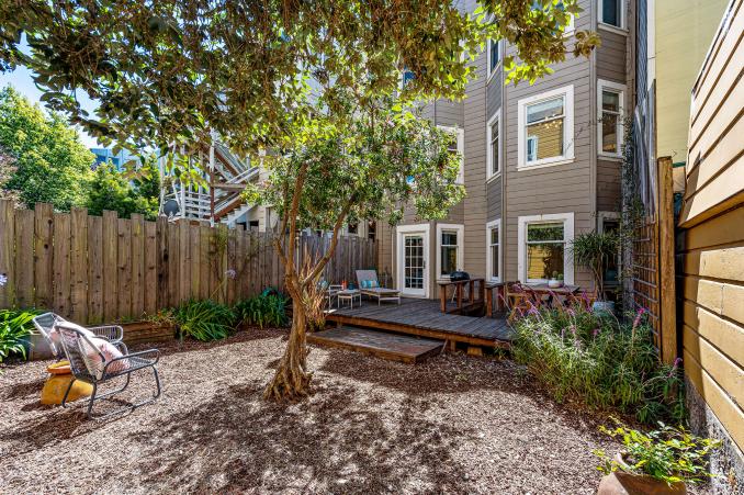 Property Thumbnail: View of the rear yard, featuring trees and an outdoor seating area