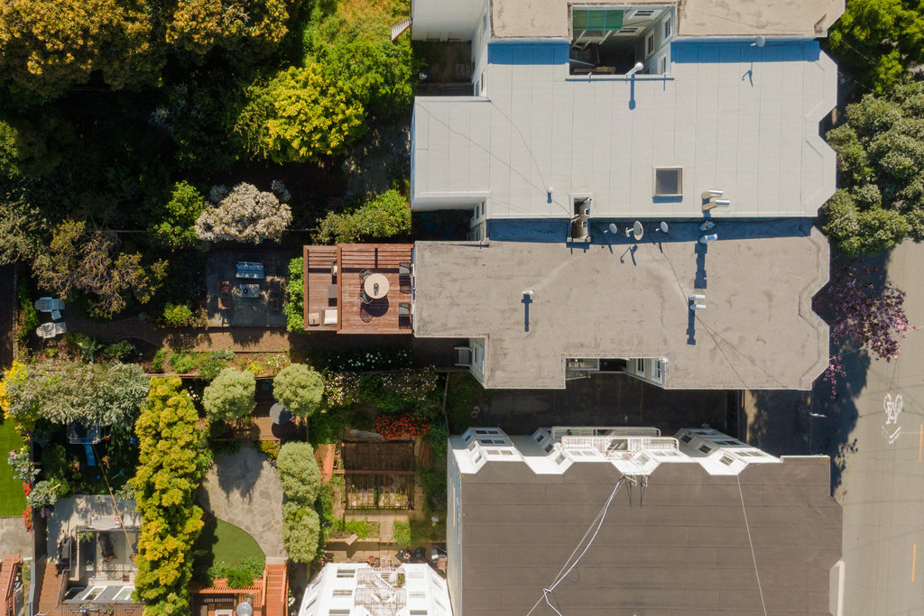 Property Photo: Aerial shot of top of building and yard. 