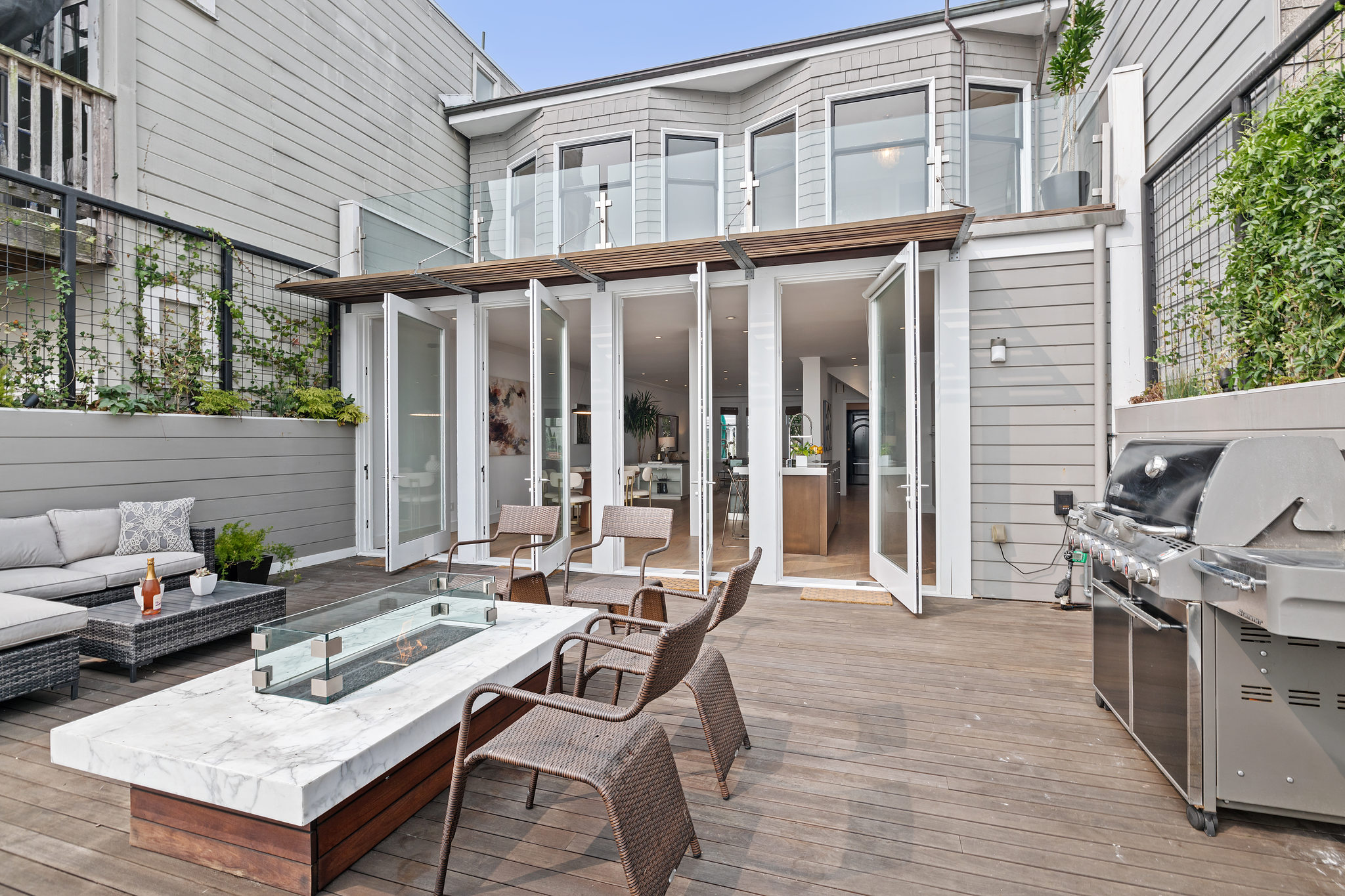 Property Photo: Upper patio at 55 Buena Vista Terrace, showing three sets of glass doors leading into the living area