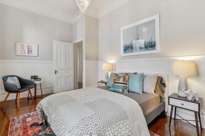 Property Thumbnail: Another bedroom with wood floors and white chair-rail 