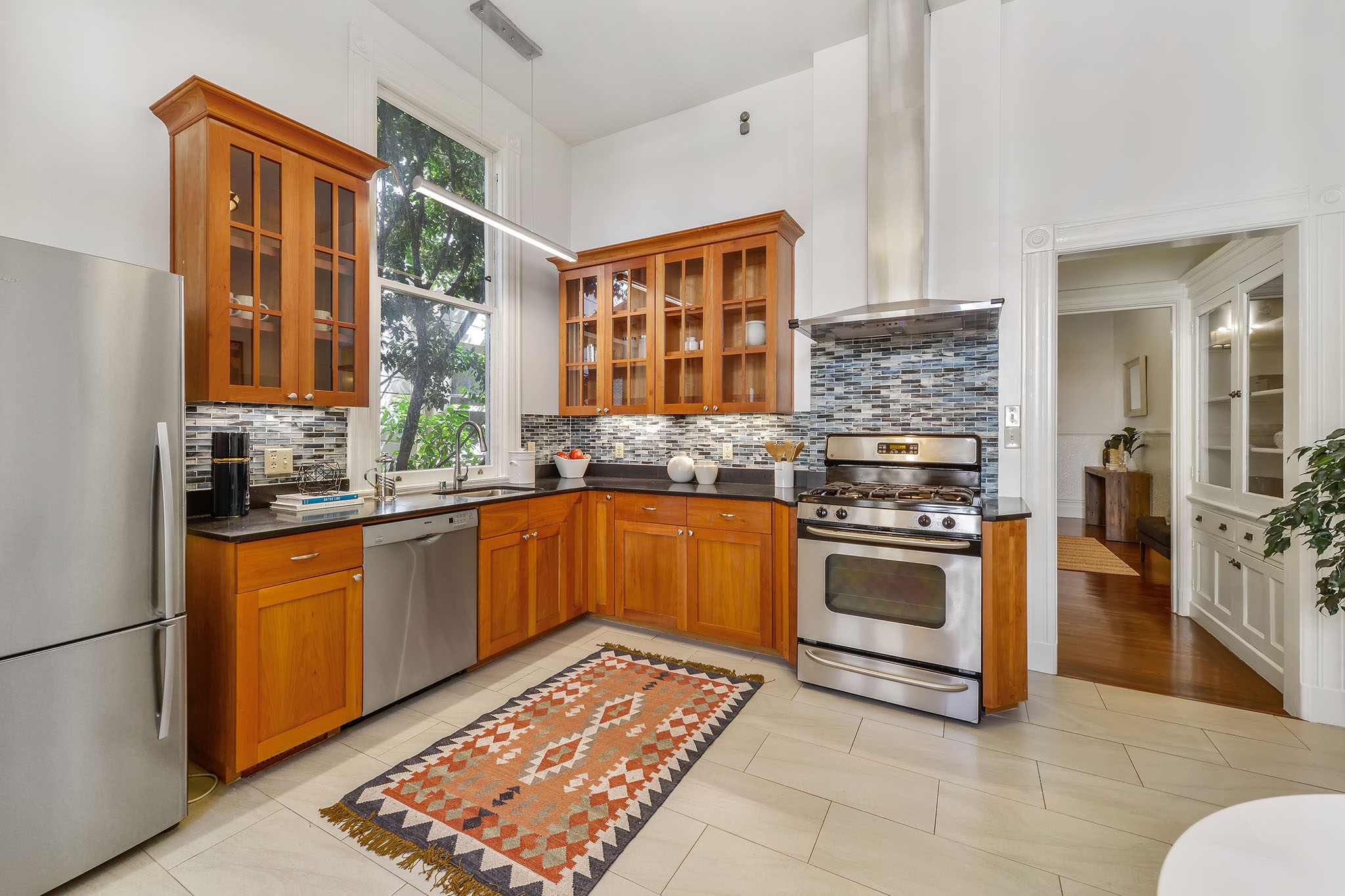 Property Photo: Kitchen with tile and wood cabinets
