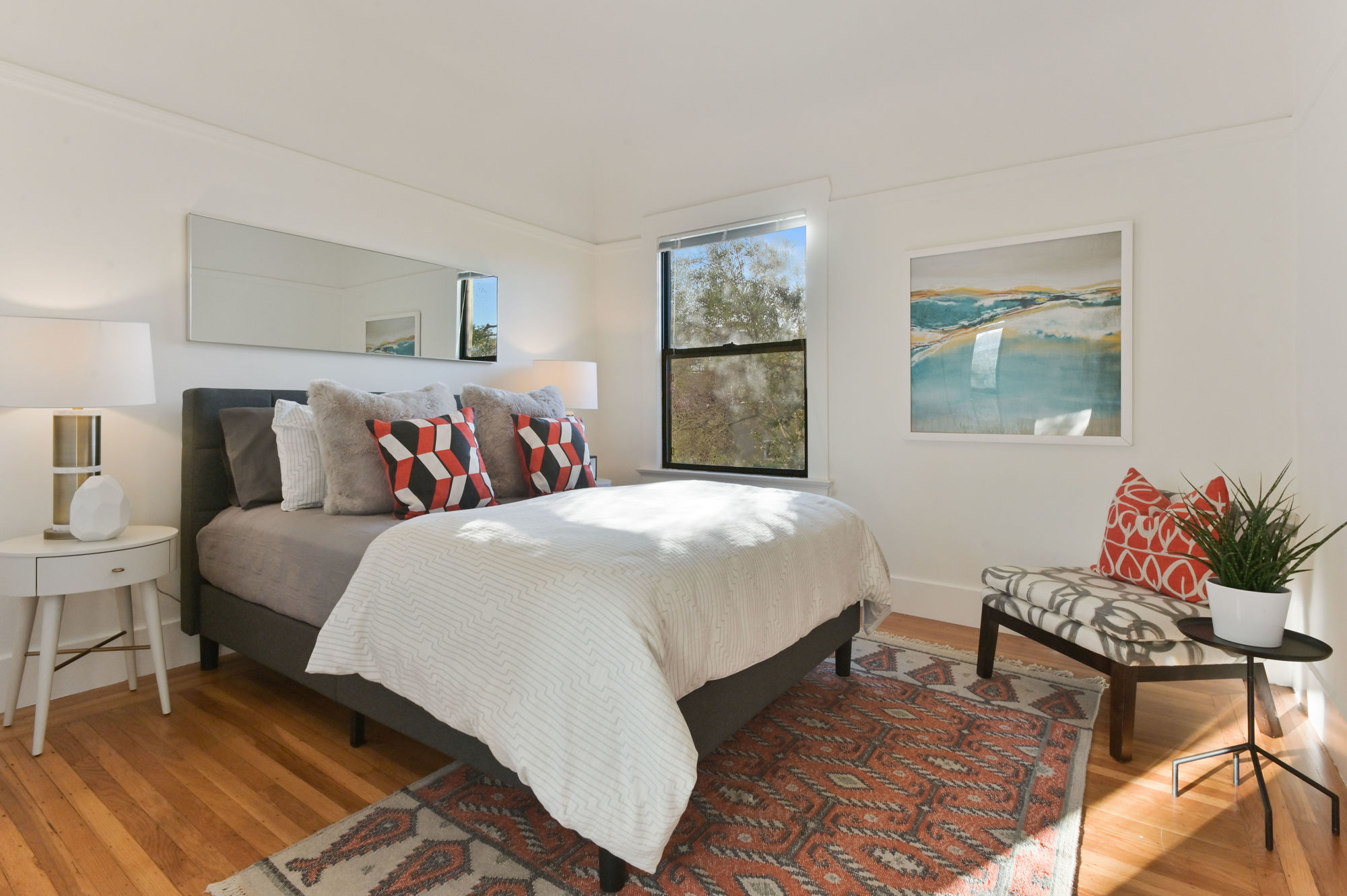 Property Photo: View of another bedroom with window and wood floors