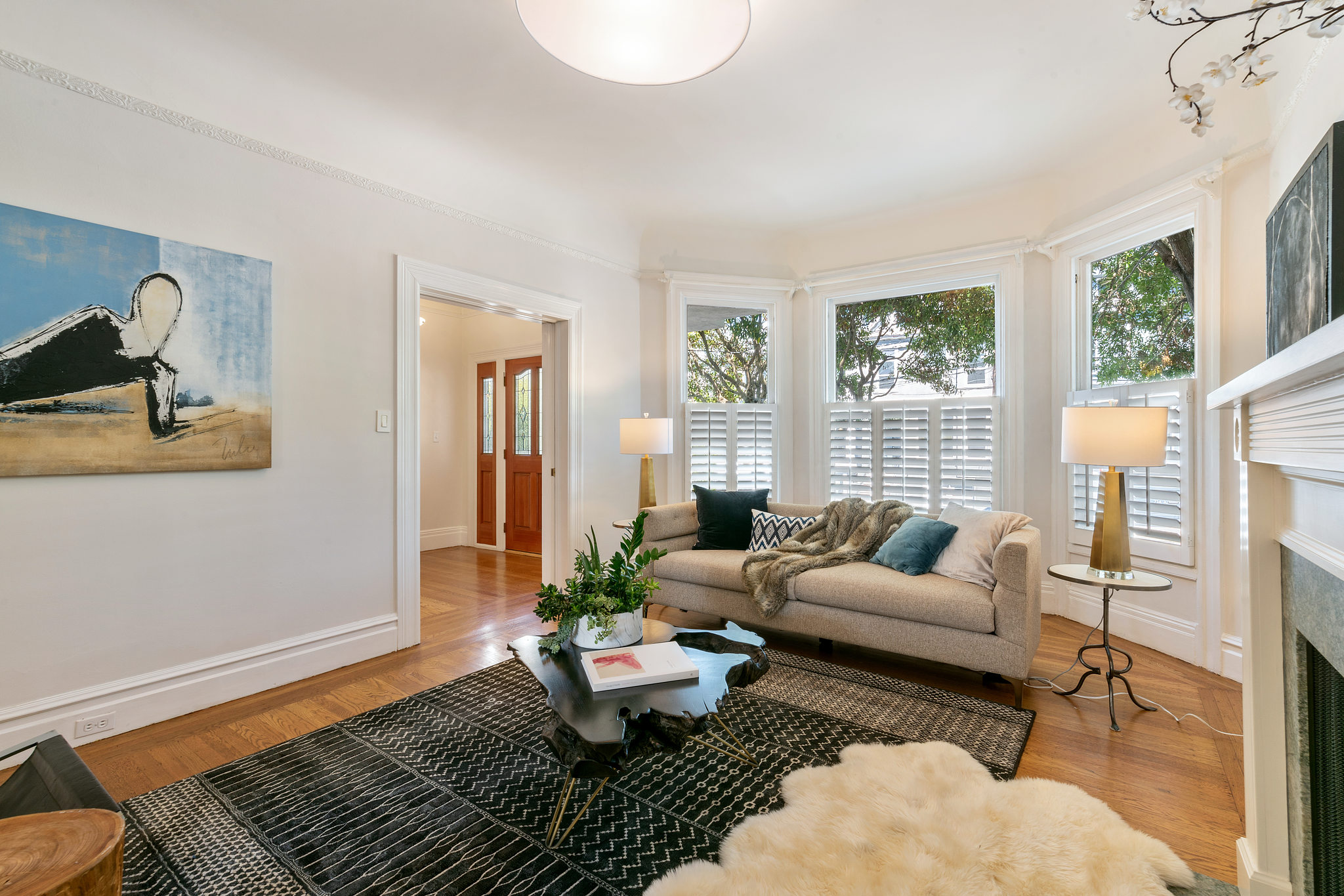 Property Photo: Living room showing bay windows and white woodwork 