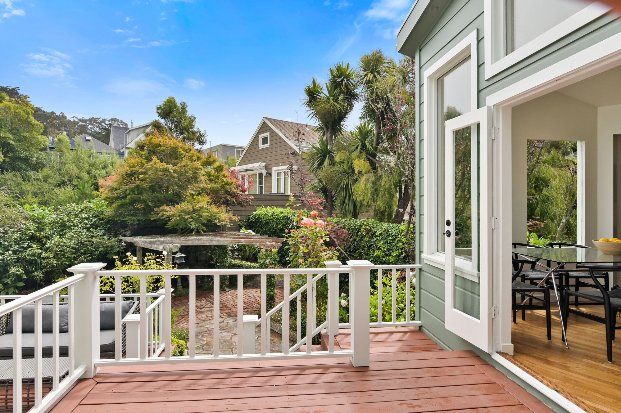 Property Photo: Deck overlooking a lush, green yard