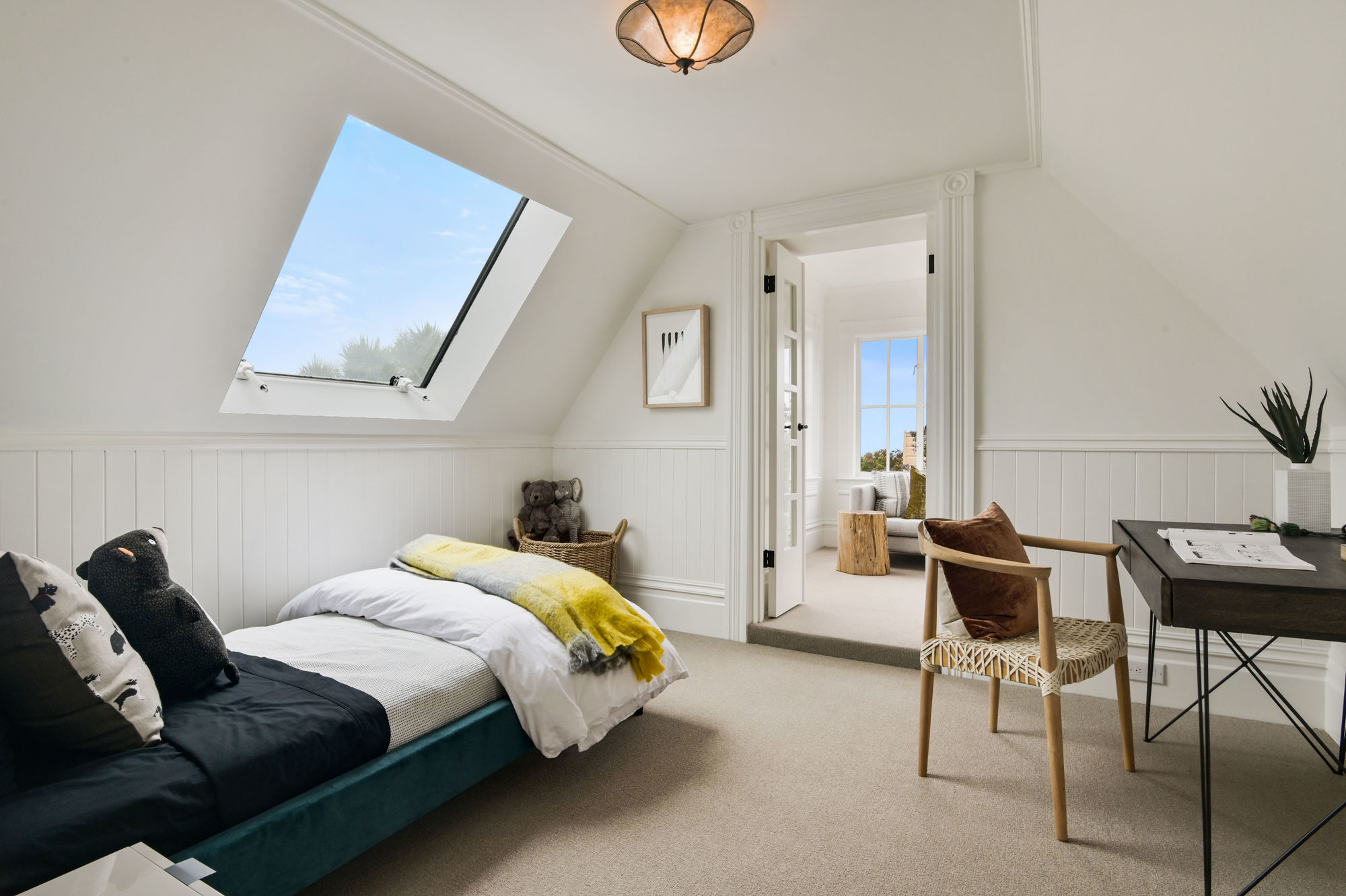 Property Photo: Bedroom with slanted ceiling and a skylight over the bed