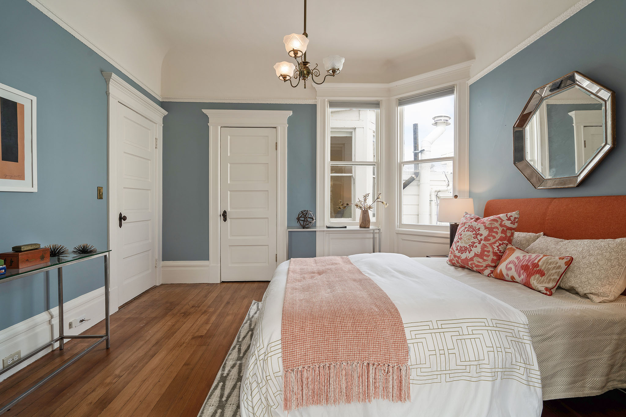 Property Photo: Bedroom with wood floors and white wood trim