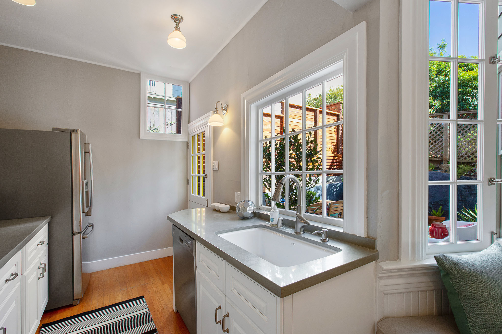 Property Photo: Kitchen, featuring large windows and sink area