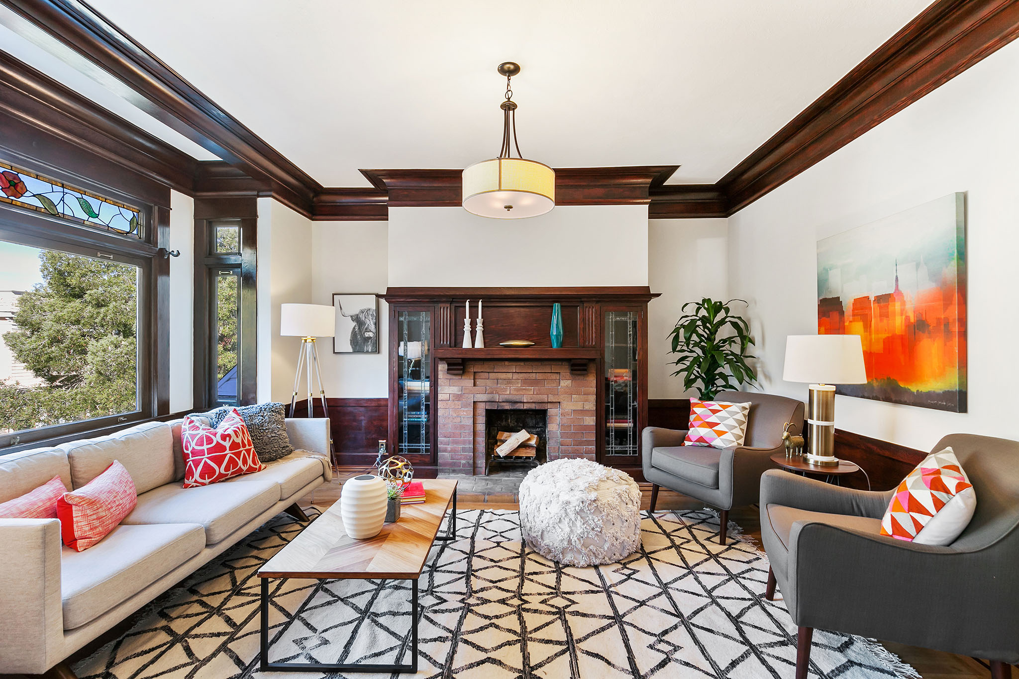 Property Photo: Living room with wood crown moulding and a fireplace