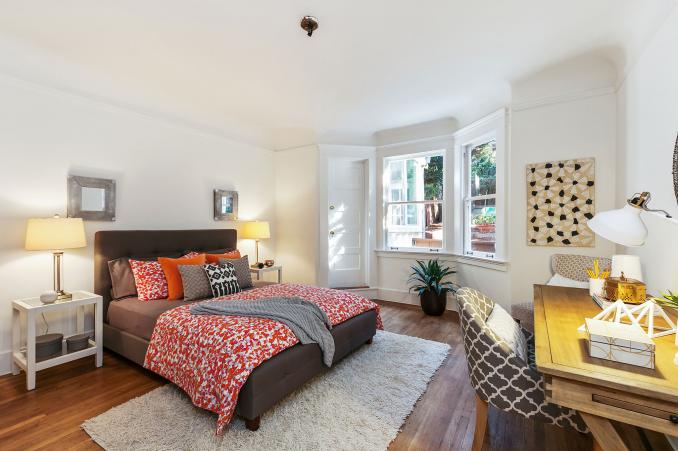 Property Thumbnail: View of a bedroom with large windows and wood floor