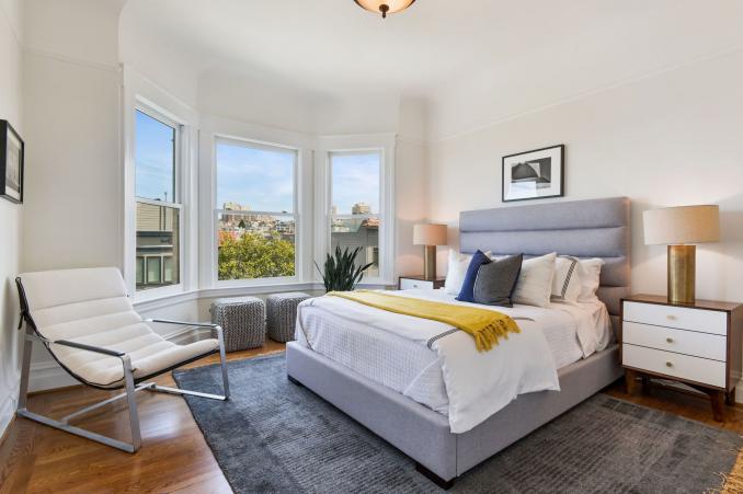 Property Thumbnail: View of a large bedroom with bay windows and wood floors