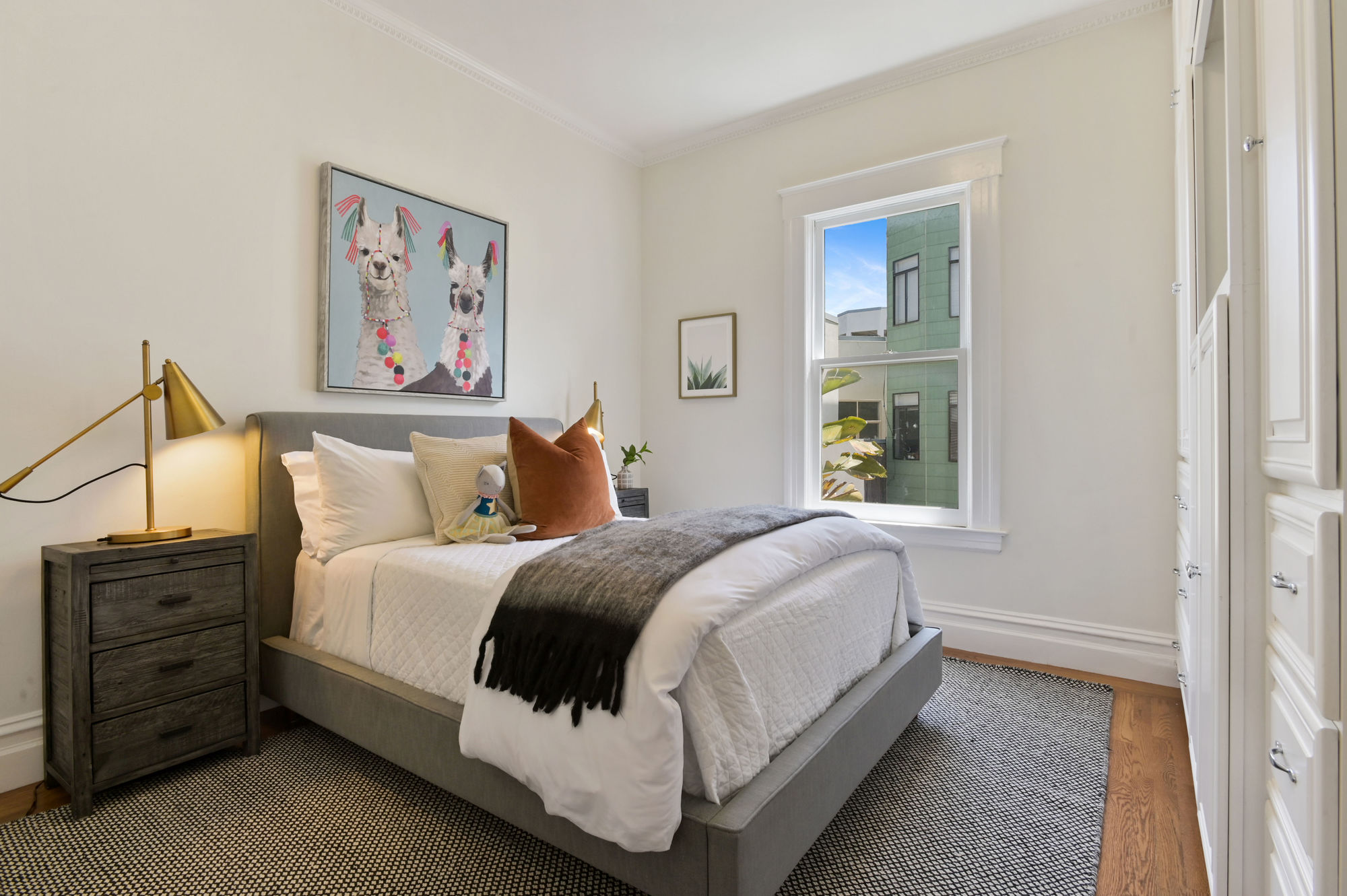 Property Photo: View of another bedroom with one large window and wood floors