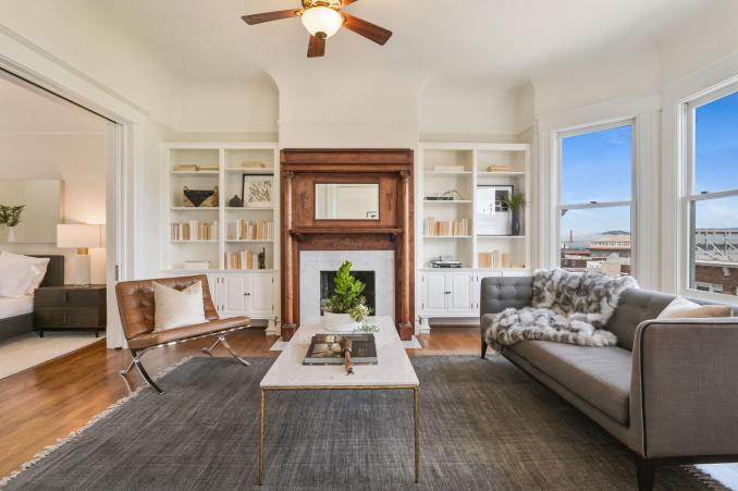 Property Thumbnail: View of the living room at 1527 Pacific Avenue, showing a fireplace with beautiful wood mantle and built-in shelves 