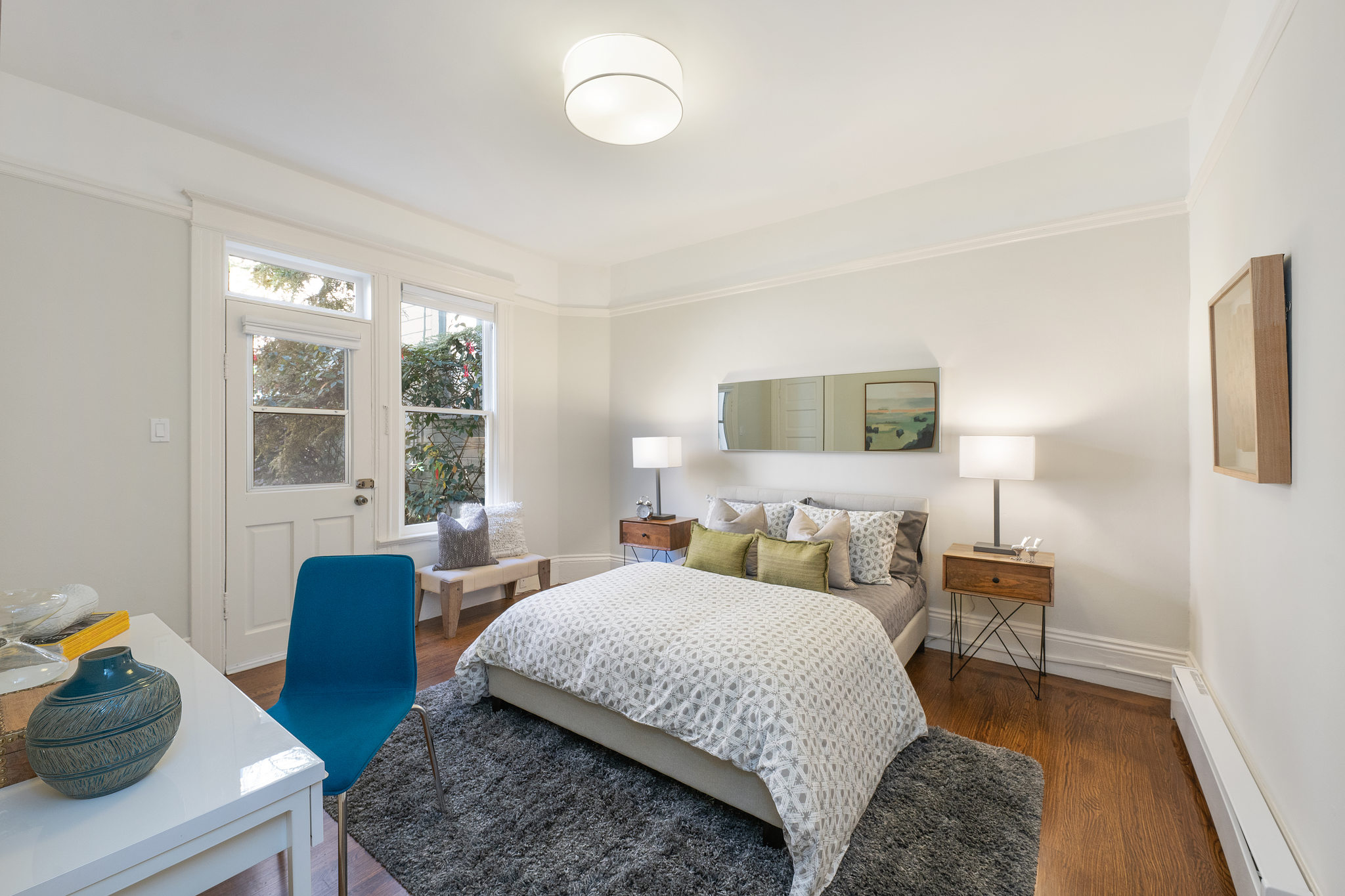 Property Photo: View of a bedroom with desk area and an exterior door 