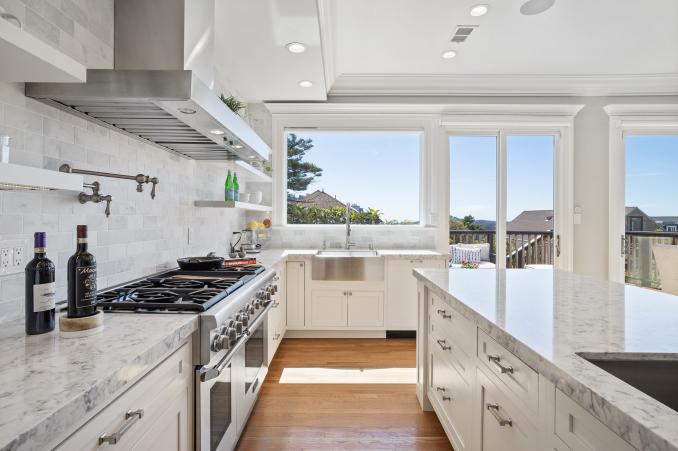 Property Thumbnail: View of the kitchen, showing the high-end stainless steel stove, marble counters and sink