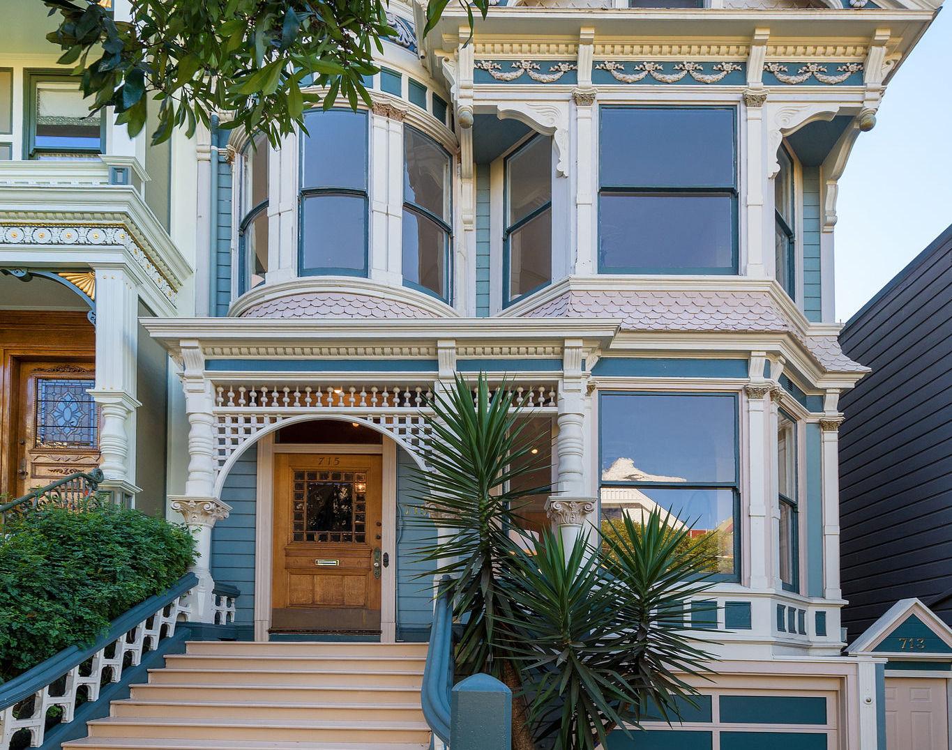 Property Photo: Front exterior of 715 Ashbury Street, showing a beautiful blue Victorian home