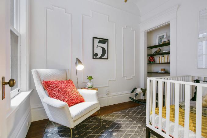 Property Thumbnail: View of a third room with white wainscoting, a large window, and a built-in shelf