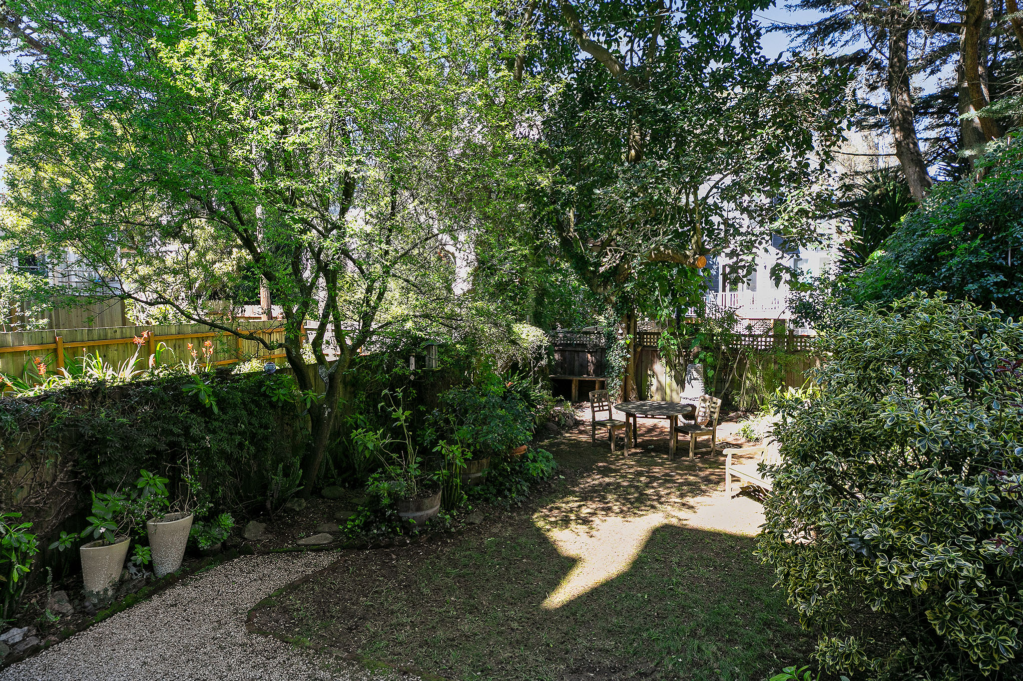 Property Photo: View of the yard, featuring landscaping and variety of trees and bushes 