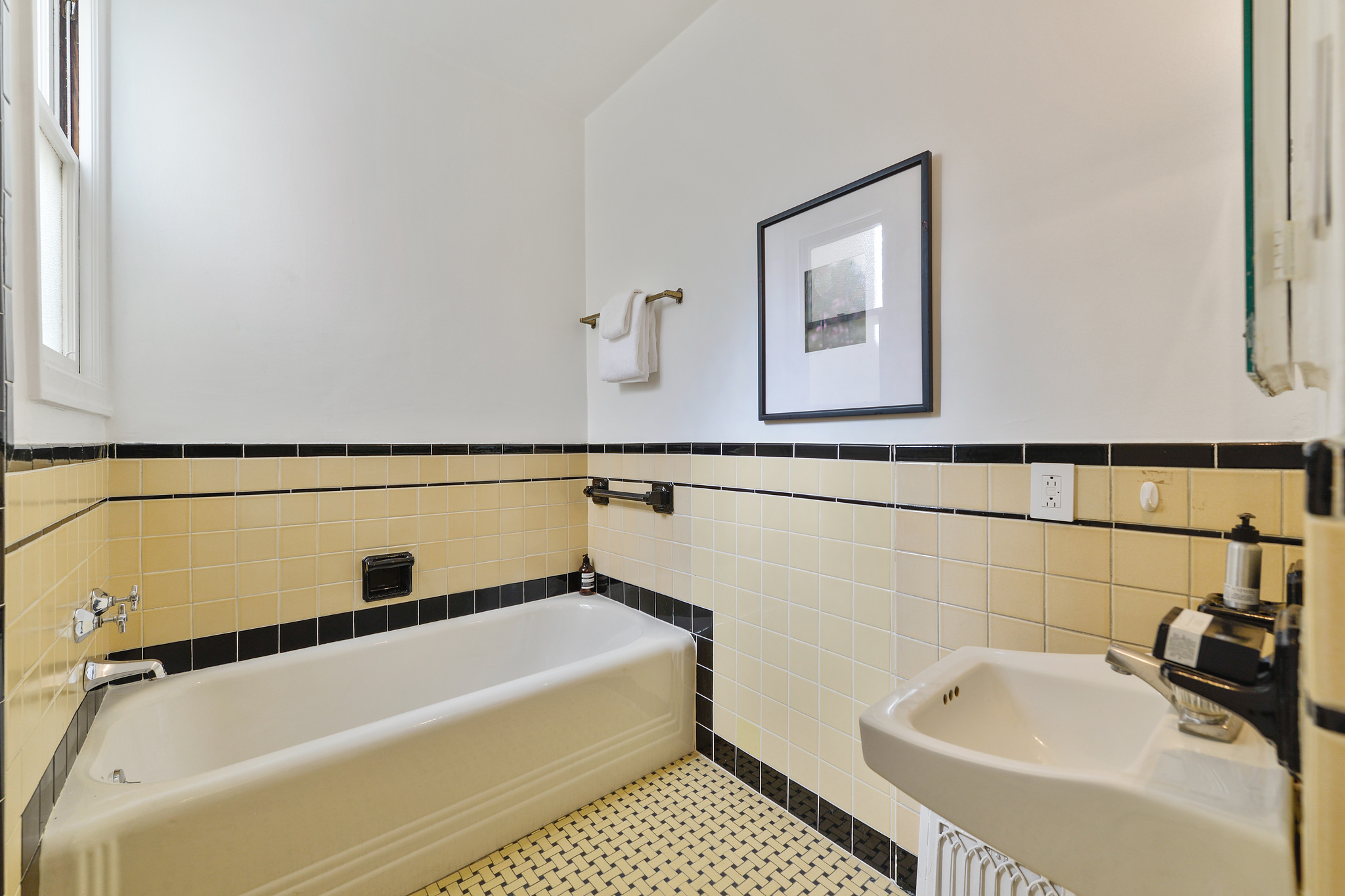 Property Photo: Art deco style bathroom with pale yellow tile