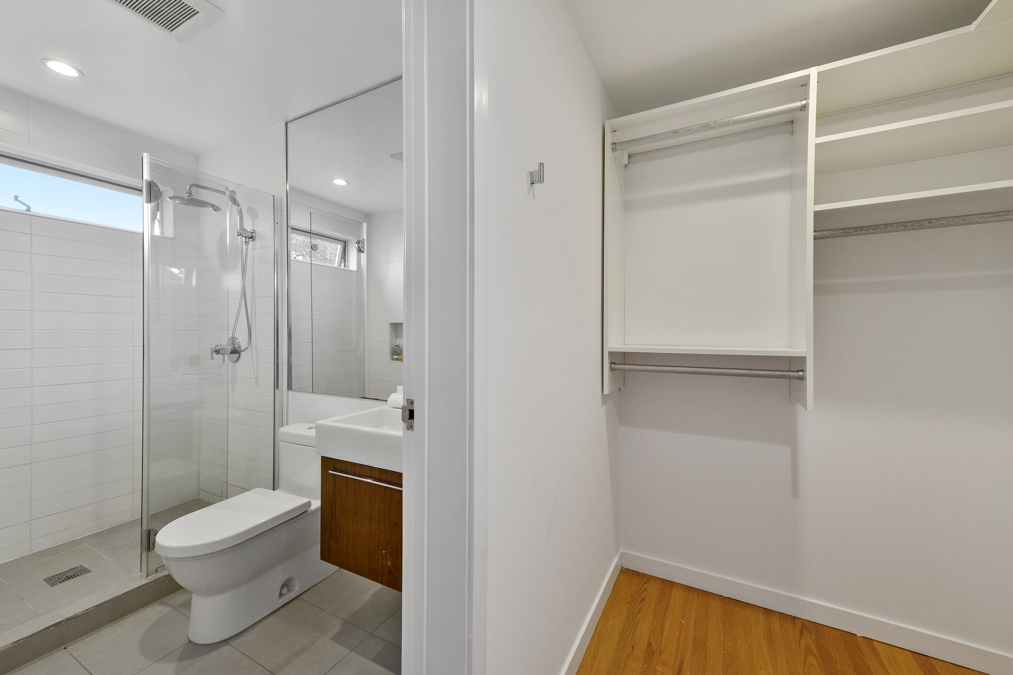Property Photo: Partial view of a bathroom and closet