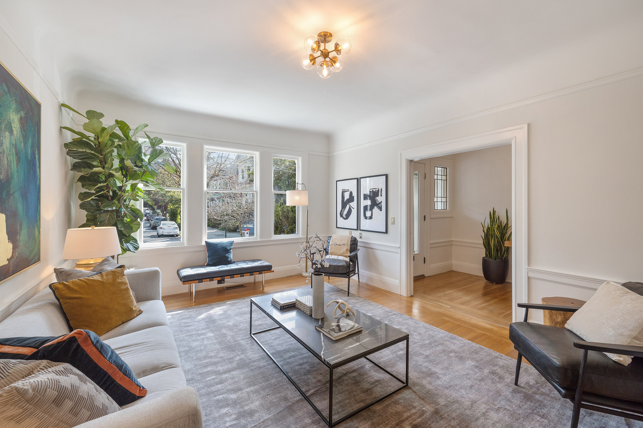 Property Photo: View of the living room showing three large windows 