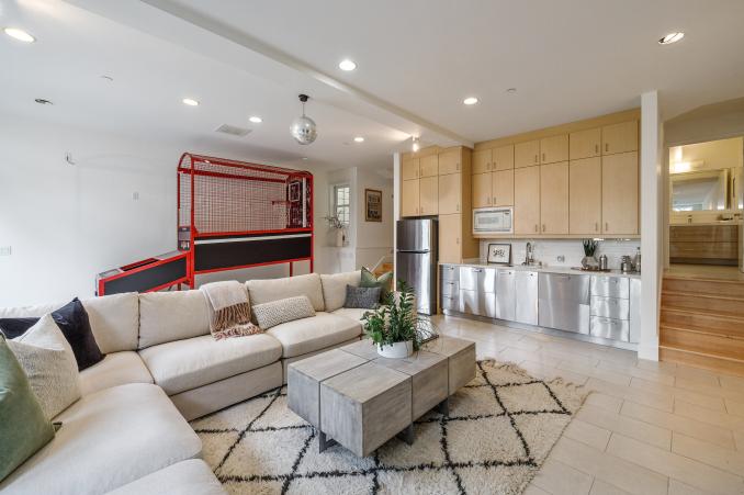 Property Thumbnail: Lower living area with a view of cabinets and bar