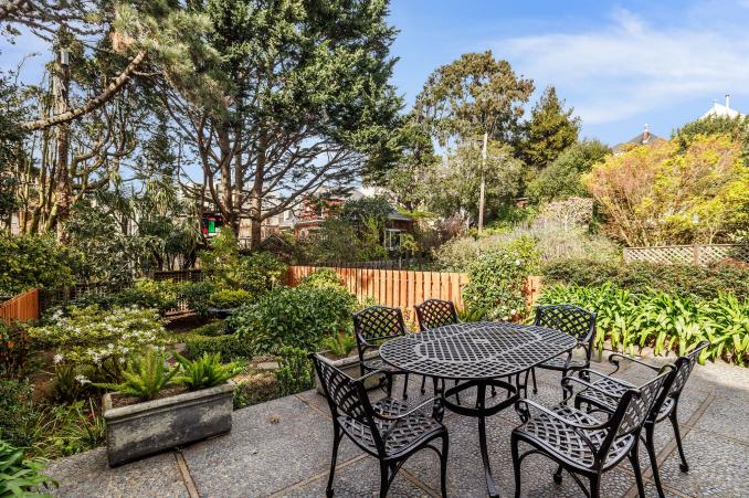 Property Thumbnail: Out door dining area, with a view of a garden area and trees