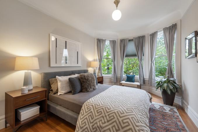 Property Thumbnail: Large bedroom with bay windows and wood floors