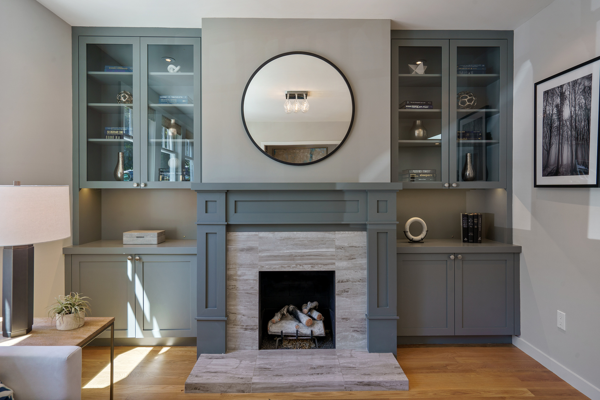 Property Photo: Close-up of the fireplace, showing a tile front, wood mantel and built-in cabinetry 
