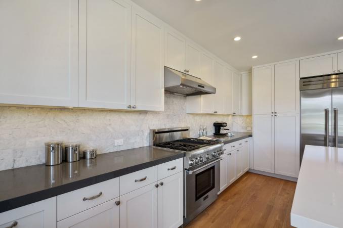 Property Thumbnail: Long view of the kitchen, showing black counter-tops
