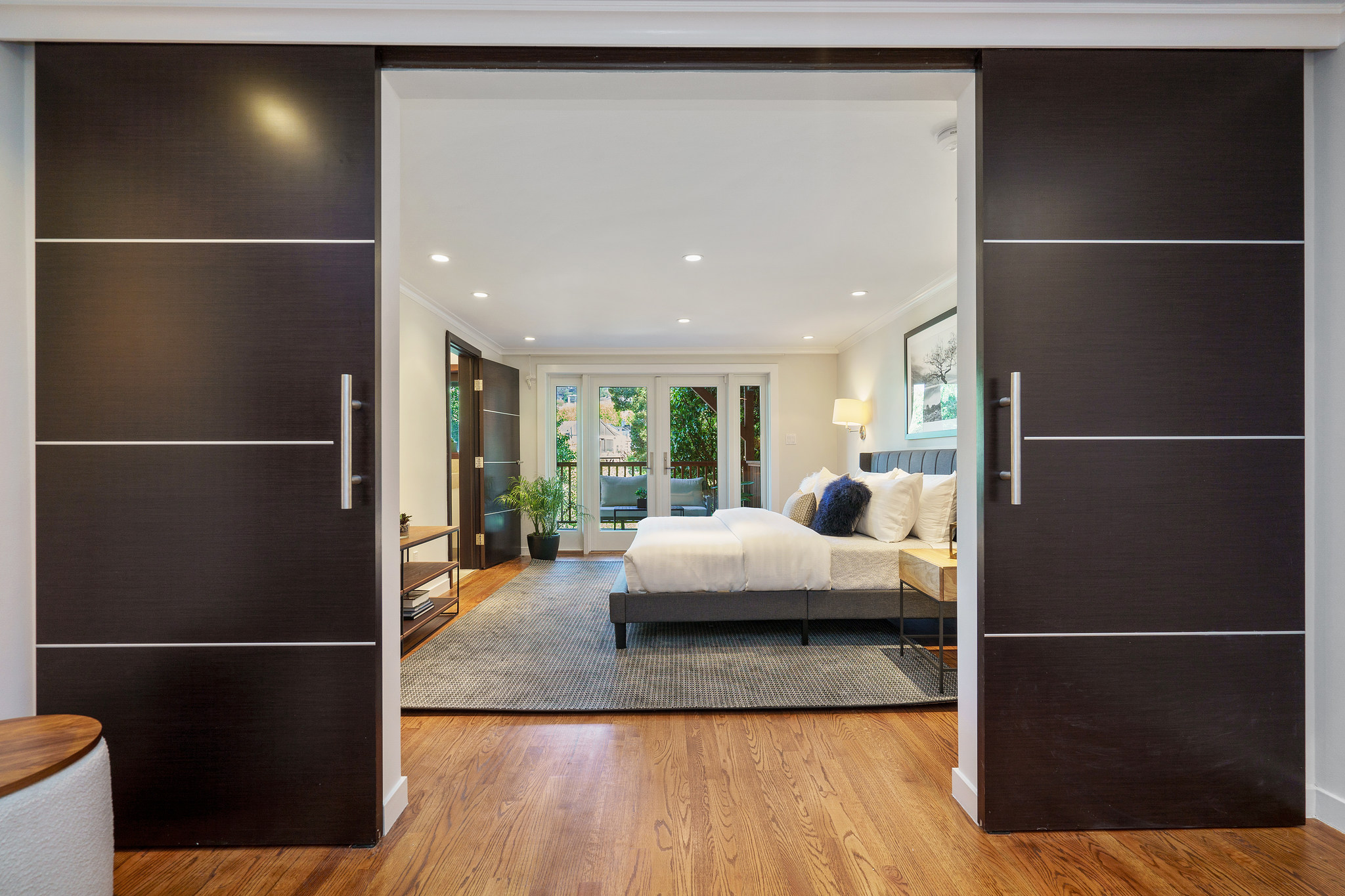 Property Photo: View of a bedroom as seen between two large doors