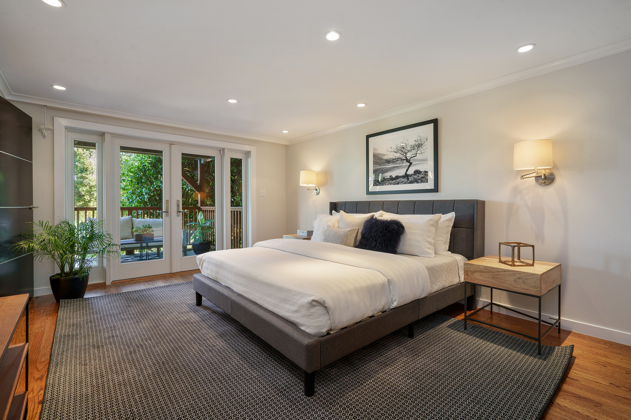 Property Photo: Lower bedroom featuring wood floors