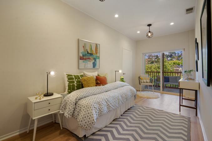 Property Thumbnail: A smaller bedroom with a daybed, wood floors and glass patio doors