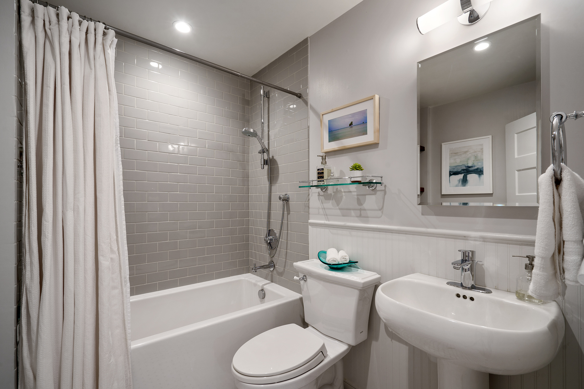 Property Photo: A bathroom with light grey tile