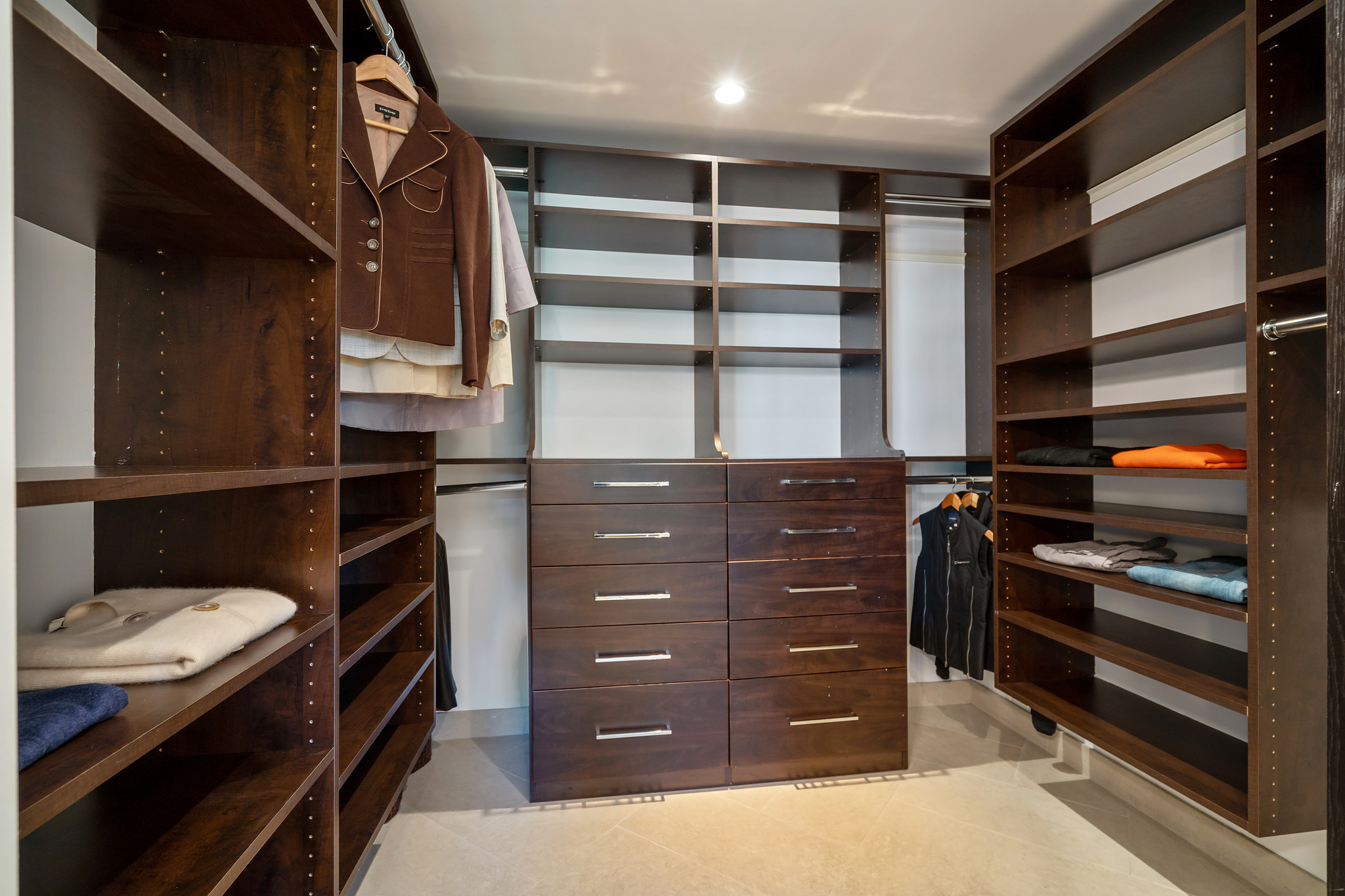 Property Photo: Large walk-in closet with built-in wood shelving 